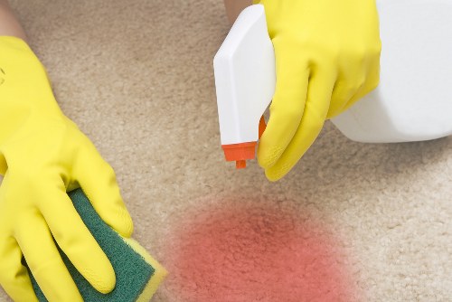 Professional home cleaners in Chiswick working in a modern living room