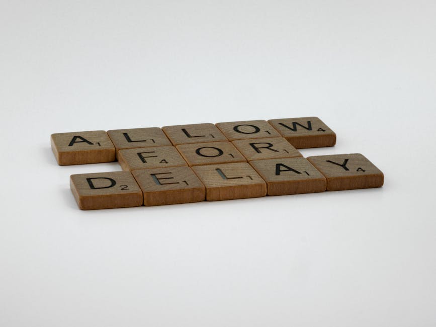 Close-up image of wooden Scrabble tiles spelling out the words 'ALLOW FOR DELAY' on a white background, representing a message about potential scheduling or service delays in the context of cleaning s